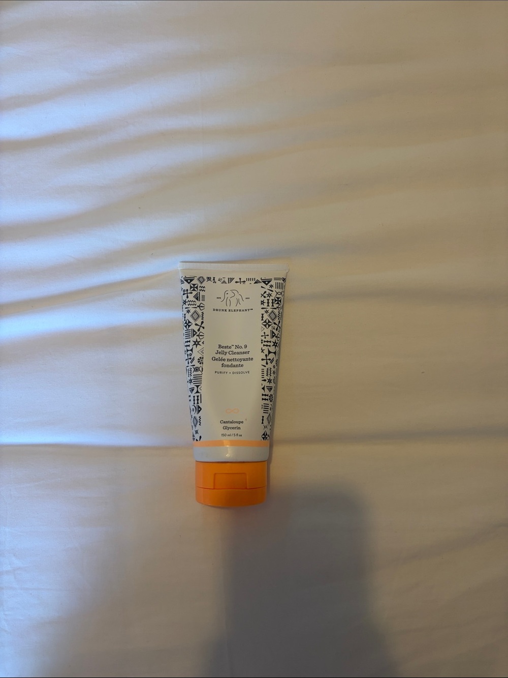 Drunk Elephant white tube with orange cap cleanser